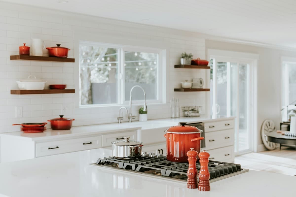 Bright white kitchen with open shelving and freshly painted walls