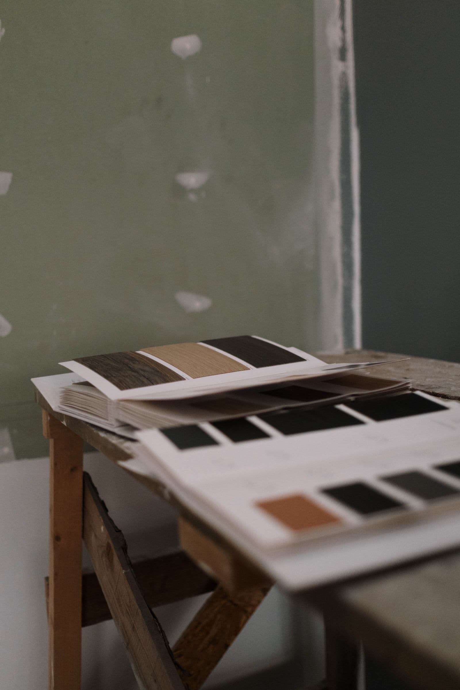 Paint sample cards laid out on a workbench