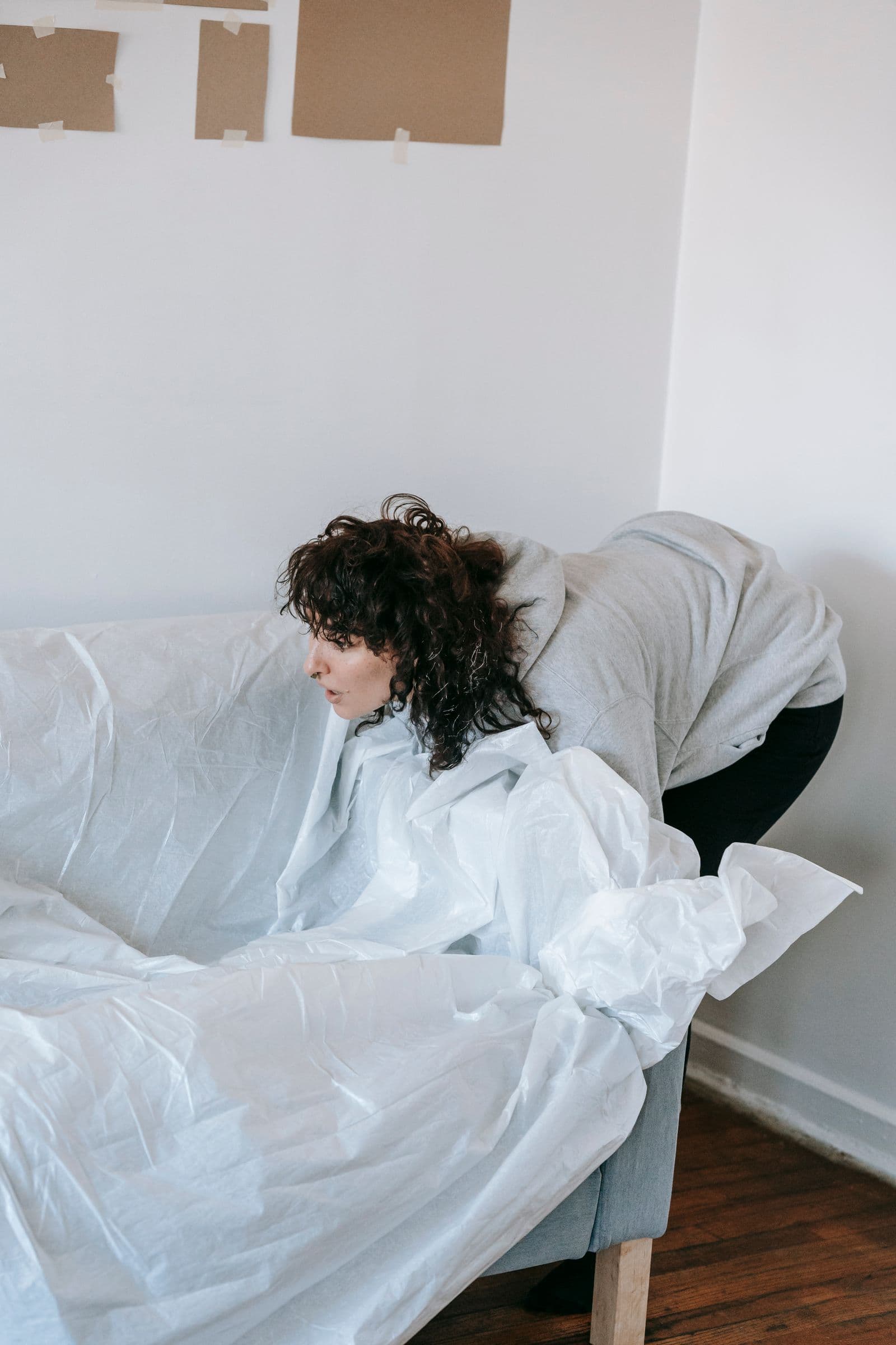 Sofa wrapped in a protective sheet before painting